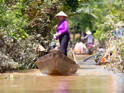 Cai Be, Vietnam - September 29, 2018: Mekong River Delta locals travel on boats on a hot summer's day